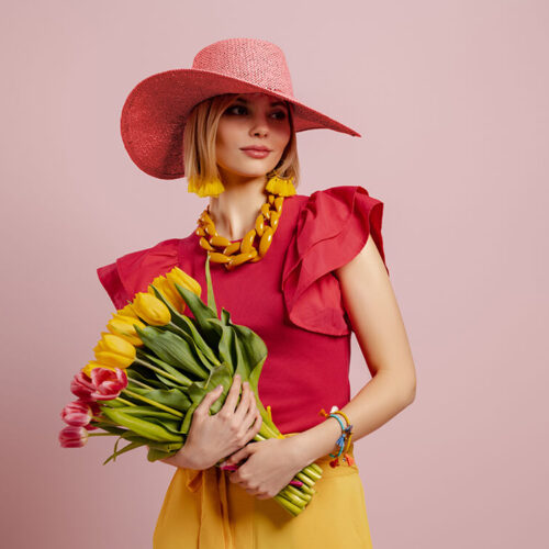 attractive-young-woman-in-elegant-hat-holding-bunc-2023-11-27-05-01-36-utc