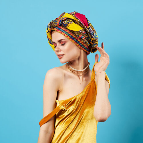 beautiful woman in multicolored turban attractive look Jewelry smile Studio Model. High quality photo