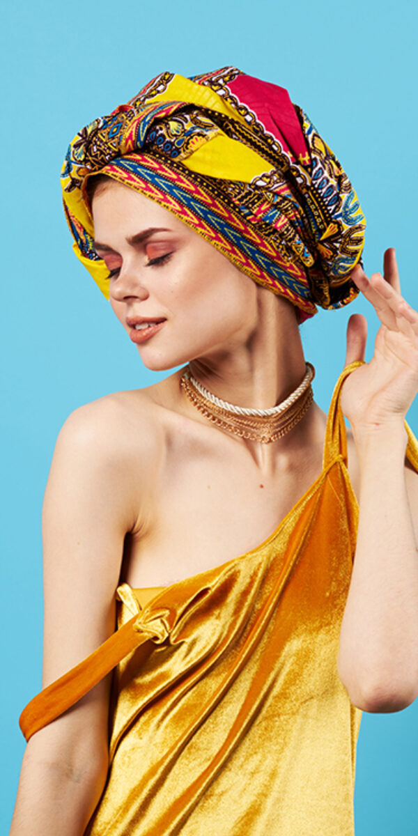 beautiful woman in multicolored turban attractive look Jewelry smile Studio Model. High quality photo