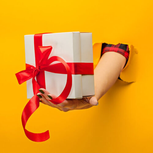 close-up-of-female-hand-holding-a-present-through-2023-11-27-05-15-50-utc