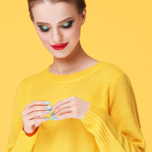 Colorful makeup woman in yellow clothes on color happy summer fashion background