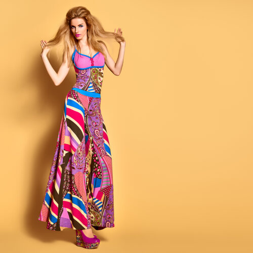 Fashion woman in colorful Summer Outfit, Glamor heels with Fashion hairstyle, Trendy Makeup. Beauty sexy blonde Model, Stylish summer look. Playful model girl, long legs. Unusual creative