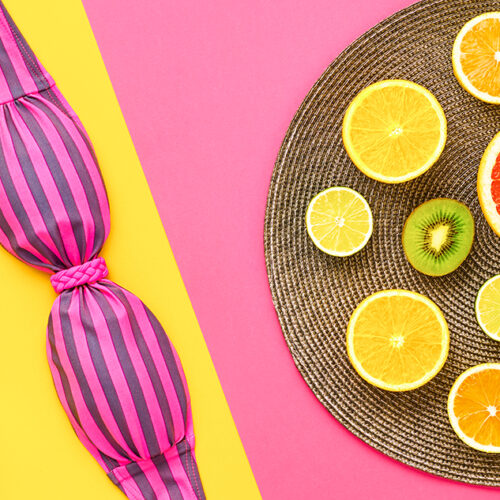 Fashion summer clothes accessories look. Beach Outfit. Trendy stylish tropical minimal on vivid geometry background. Fashionable layout, summertime advertising concept, top view