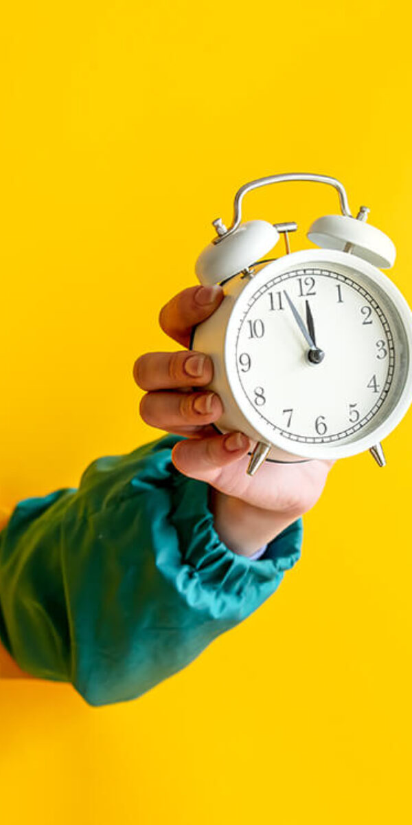 female-hand-hold-vintage-white-alarm-clock-on-yell-2024-09-25-06-50-09-utc