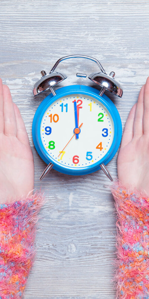 female-hands-holding-clock-on-a-table-2024-09-30-04-43-14-utc