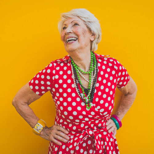 happy-grandmother-posing-on-colored-backgrounds-2023-11-27-05-16-54-utc