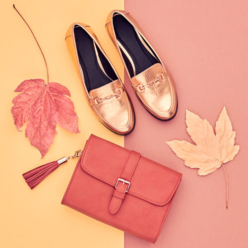 Fall Fashion Glamour Lady Look. Autumn Minimal Design.Trendy Handbag Clutch. Fashion Stylish Glamour Gold Shoes. Yellow Fall leaves.