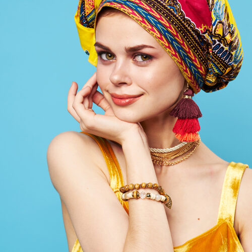 pretty woman ethnicity multicolored headscarf makeup glamor isolated background. High quality photo