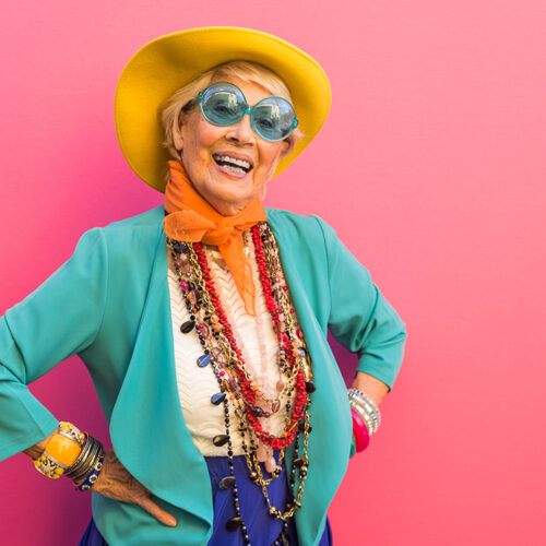 Happy and playful senior woman having fun - Portrait of a beautiful lady above 70 years old with stylish clothes, concepts about senior people