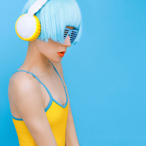 sensual DJ-lady in style headphones listening to music