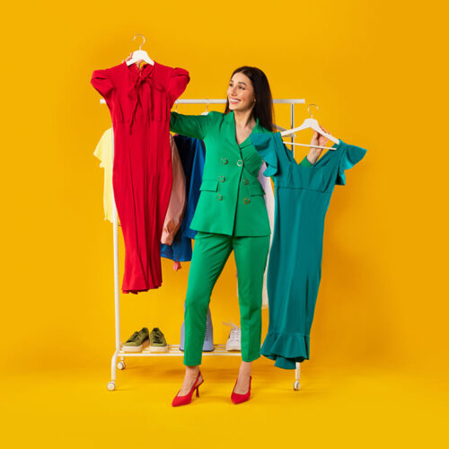 shopaholic-happy-elegant-woman-choosing-dresses-h-2023-11-27-04-55-29-utc
