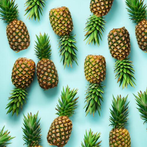 Square crop. Fresh pineapples on blue background. Top View. Pop art design, creative concept. Copy Space. Bright pineapple pattern for minimal style