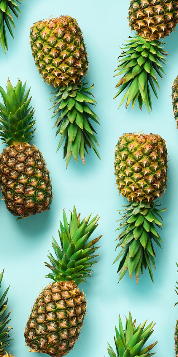 Square crop. Fresh pineapples on blue background. Top View. Pop art design, creative concept. Copy Space. Bright pineapple pattern for minimal style