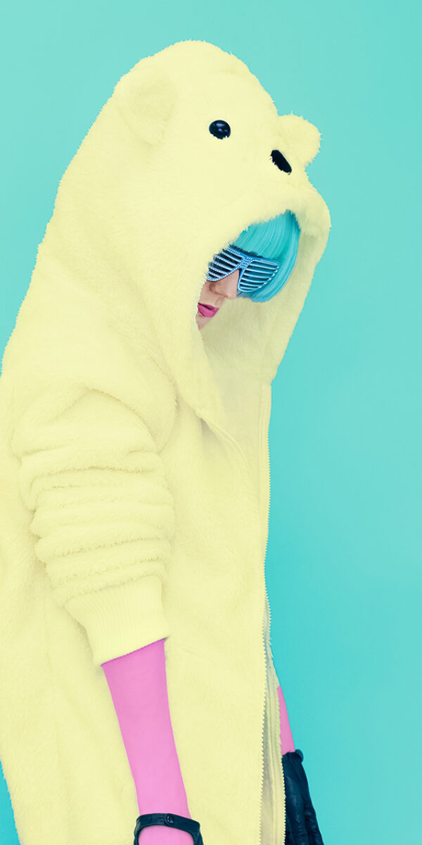 Teddy bear crazy girl in a bright hoodie on a blue background color exclusive