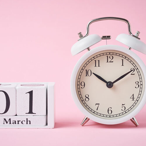 white-retro-alarm-clock-and-wooden-calendar-blocks-2023-11-27-04-51-53-utc