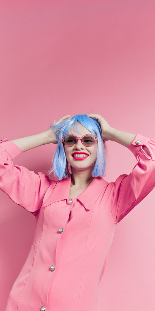 woman in blue wig pink dress red lips Lifestyle posing. High quality photo