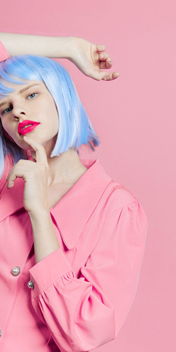 woman in blue wig pink dress red lips Lifestyle posing. High quality photo